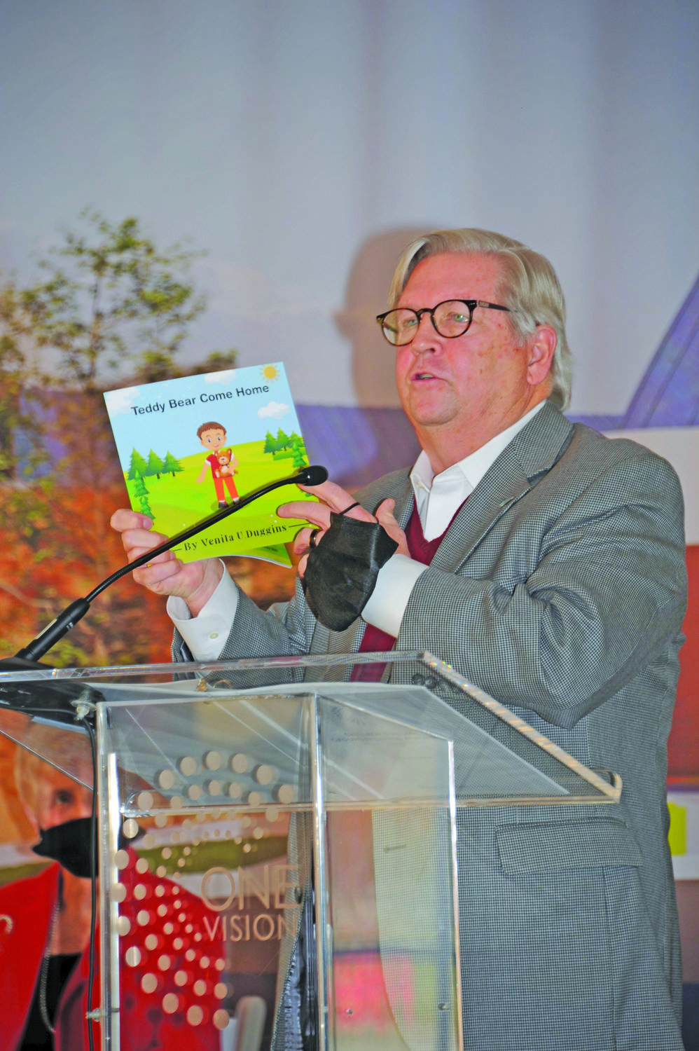 Jim Brexler, president and CEO of Doylestown Health, holds up a book written by a student’s great-grandmother about the tornado.