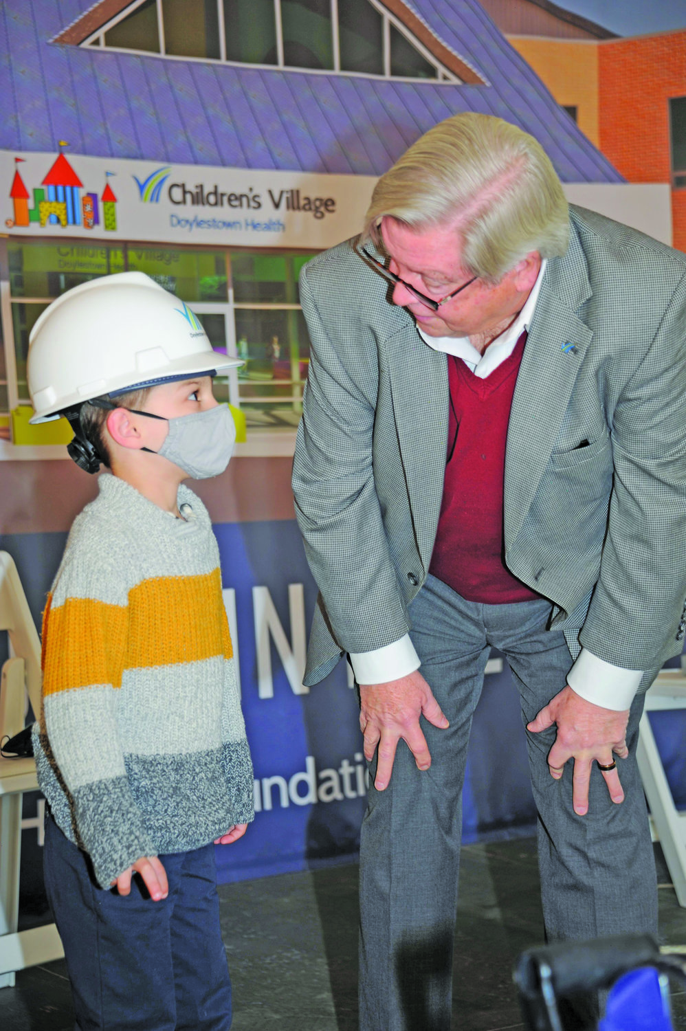 Doylestown Health President and CEO Jim Brexler and Gianluca Ferraguti, 5, who was a student at Children’s Village when it was hit by a tornado. His great-grandmother, Venita U. Duggins, wrote a children’s book for him called “Teddy Bear Comes Home,” about his experience in the storm and losing his Teddy bear. The book is written to help alleviate children’s fear of bad weather. The Ferragutis are donating all proceeds from the book to the rebuilding project for Children’s Village.