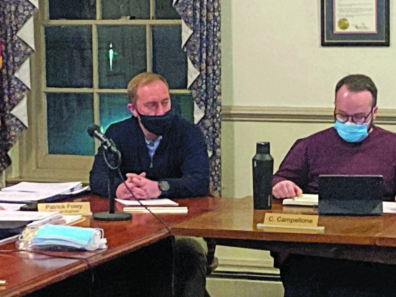 Yardley Borough council member Matt Curtin, left, at the Feb. 1 meeting after being sworn in for another two-year term. Sitting with him is council member Chris Campellone.