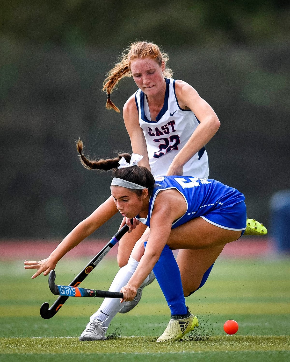 Bensalem’s Haley Groves falls in front of Central Bucks East’s Paige Keller while chasing a loose ball.