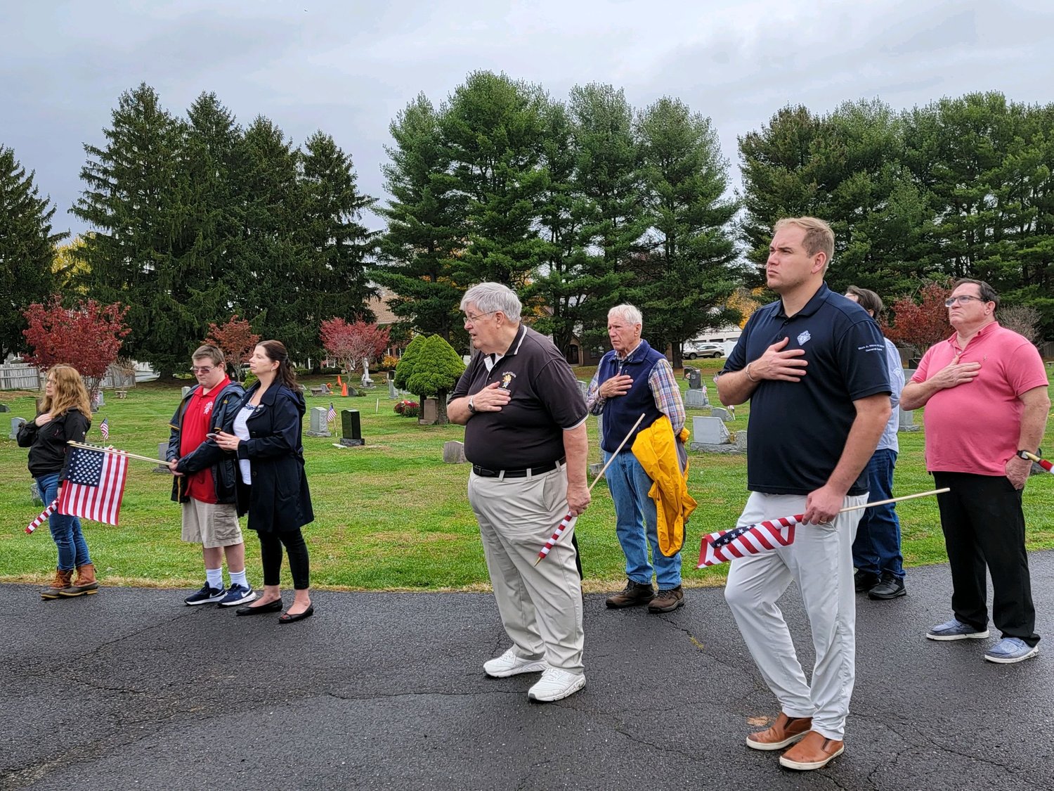 Tom Hendricks of Doylestown (black shirt, beige pants) recites the Pledge of Allegiance during the ceremony.