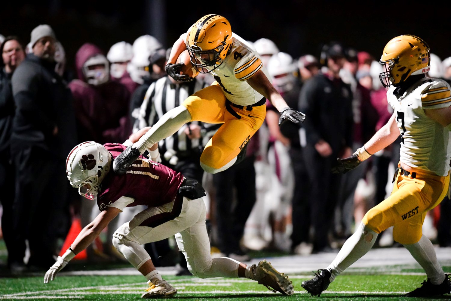 CB West’s Eli Boehm leaps over Garnet Valley’s Justin Gretsky after catching a 33-yard pass from Ganz Cooper and taking it all the way, cutting the Jaguars’ lead to 14-7.