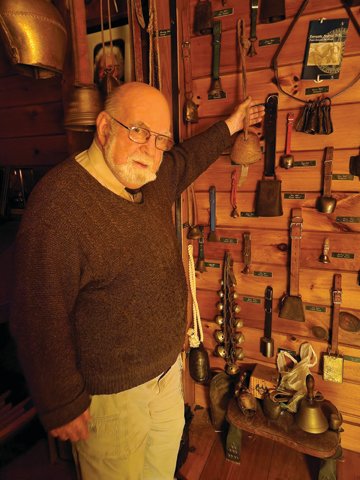 Dr. James Diamond holds a camel bell from Saudi Arabia, one of 88 domestic animal bells in his collection.