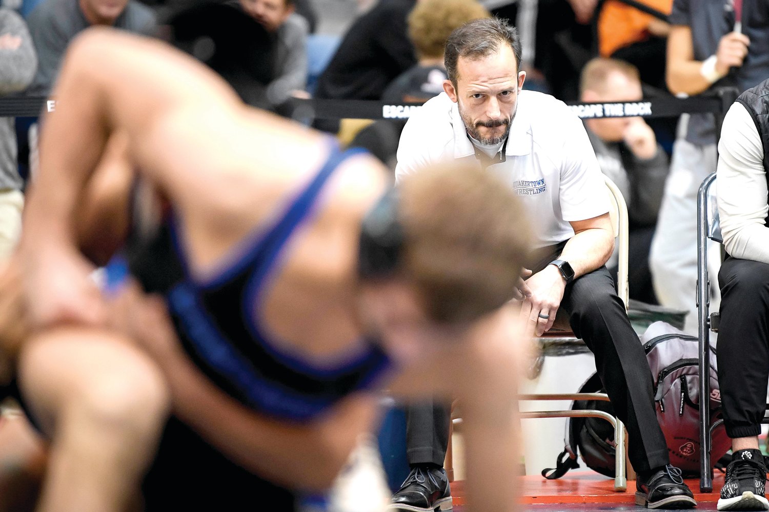 Quakertown coach Dan Ziegler watches his son, Mason Ziegler, during a quarterfinal match.