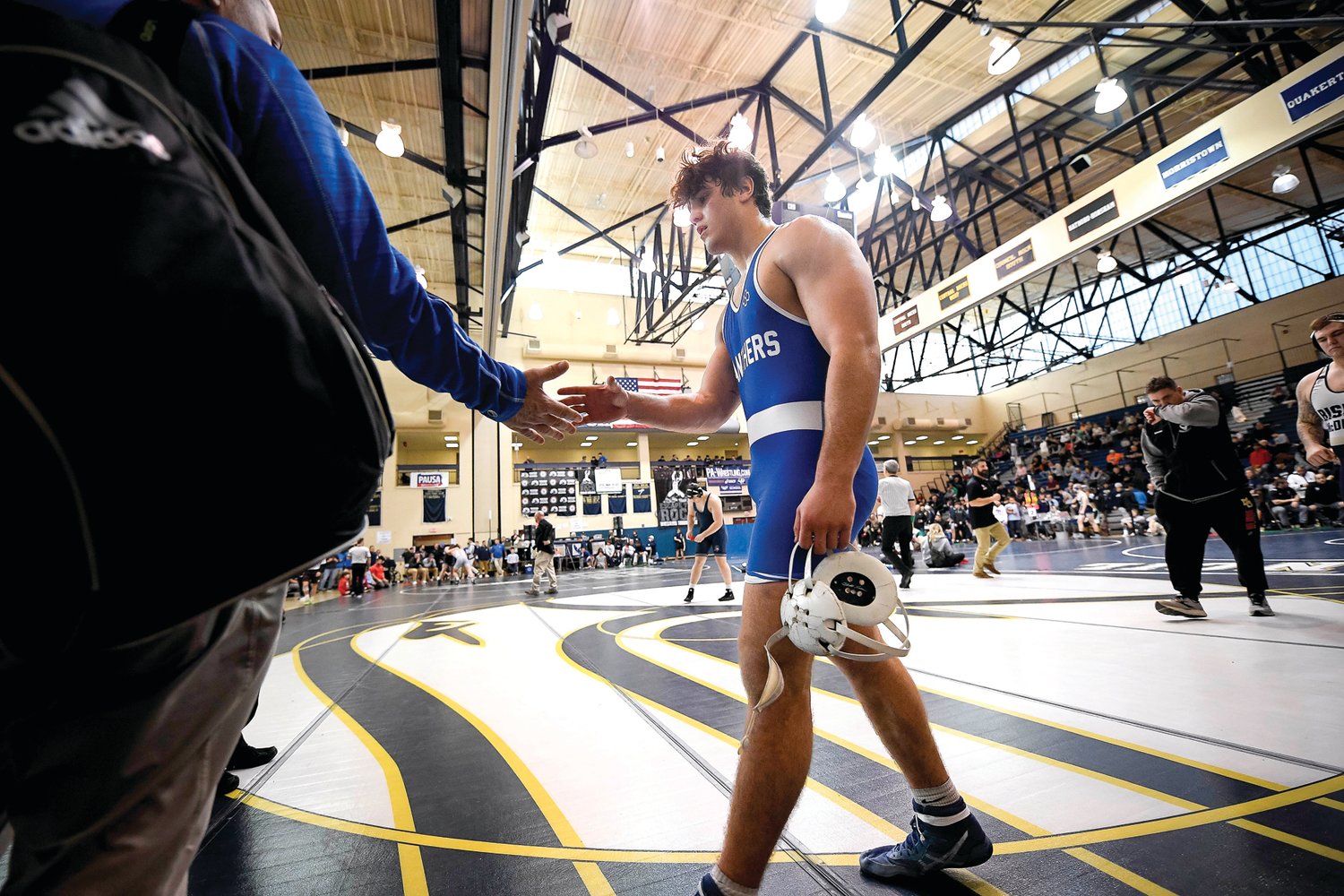 Quakertown’s Calvin Lachman gets a handshake from the coaches after his semifinal loss.