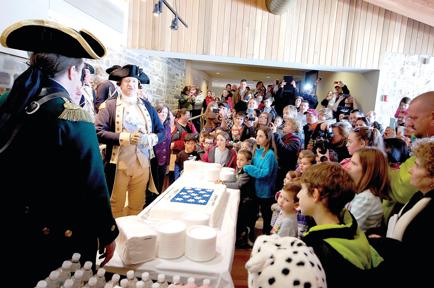 “George Washington” is ready to cut his birthday cake with his sword. He plans to do so again during a Feb. 19 celebration at Washington Crossing Historic Park (PA).