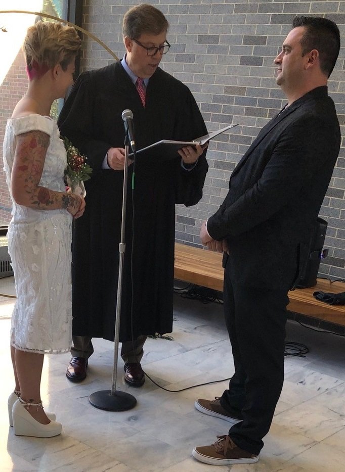 Kristen and Ryan Soltis renew their vows with Judge Brian T. McGuffin Feb. 14 in a “Vows and Valentines” ceremony at the old Bucks County courthouse in Doylestown. The event was organized by Linda Bobrin, Bucks County Register of Wills and Clerk of Orphans’ Court, with help from county and district justices.