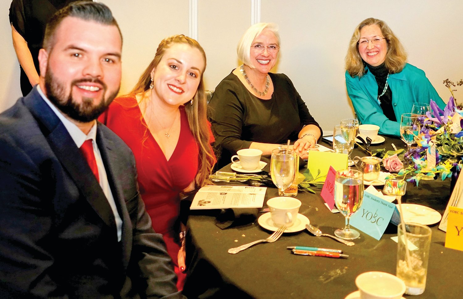 Attendees pose for a photo during the YOBC benefit.