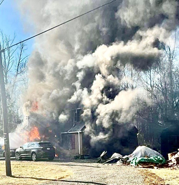 Black smoke pours out of the Finger family’s Nockamixon home on Feb. 26. No one was hurt, but the blaze destroyed the house on Perry Auger Road.