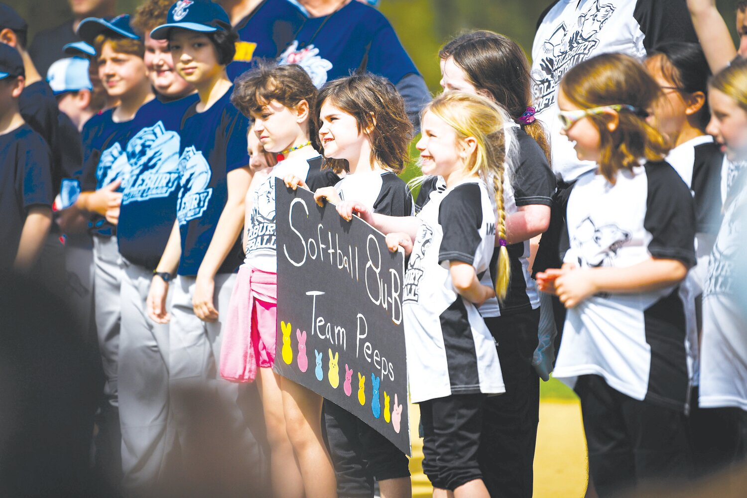 Members of the softball 8U Team Peeps line up for the opening ceremony.