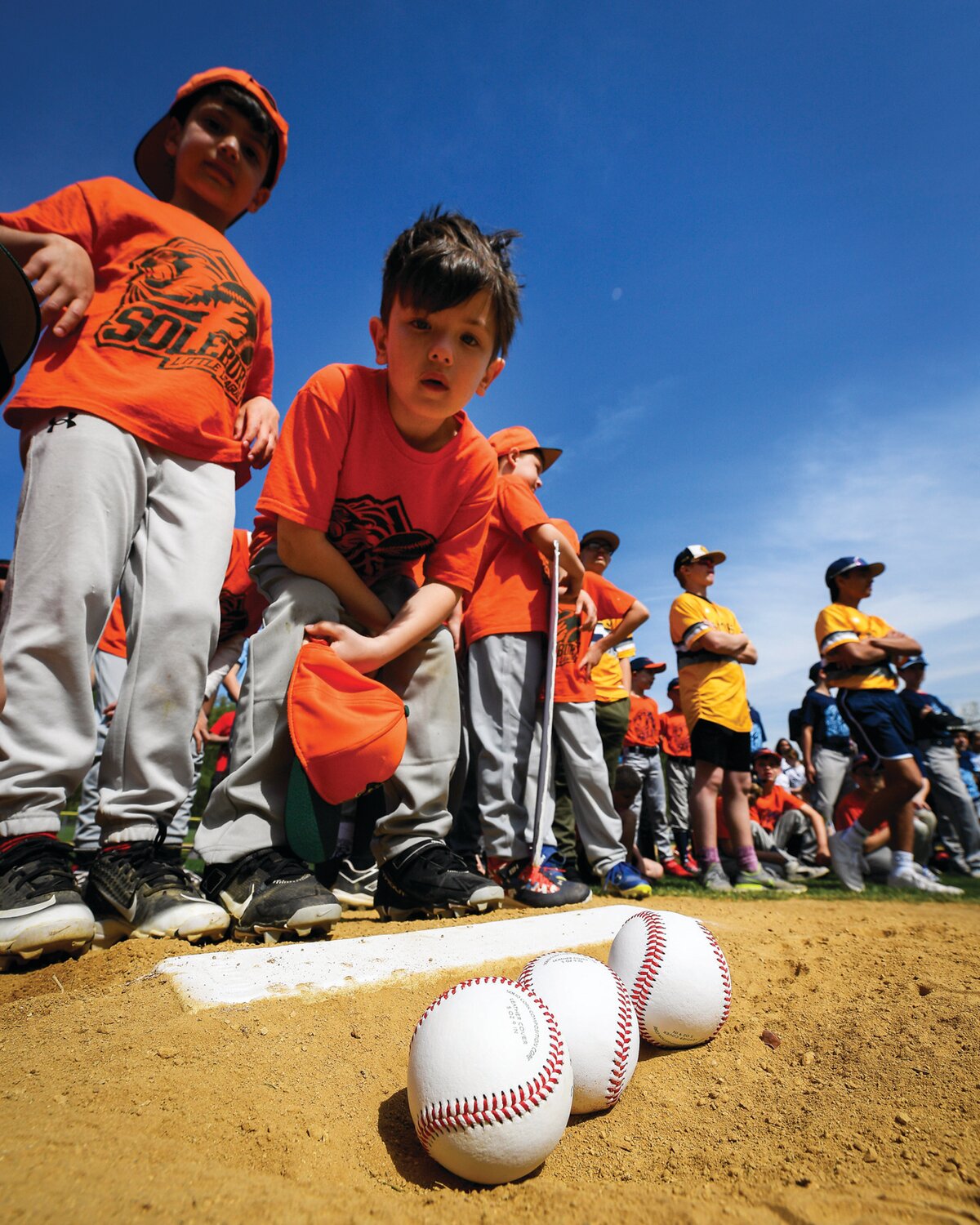 Howie Keyes, 7, checks out the baseballs to be used for the first pitches of the season.