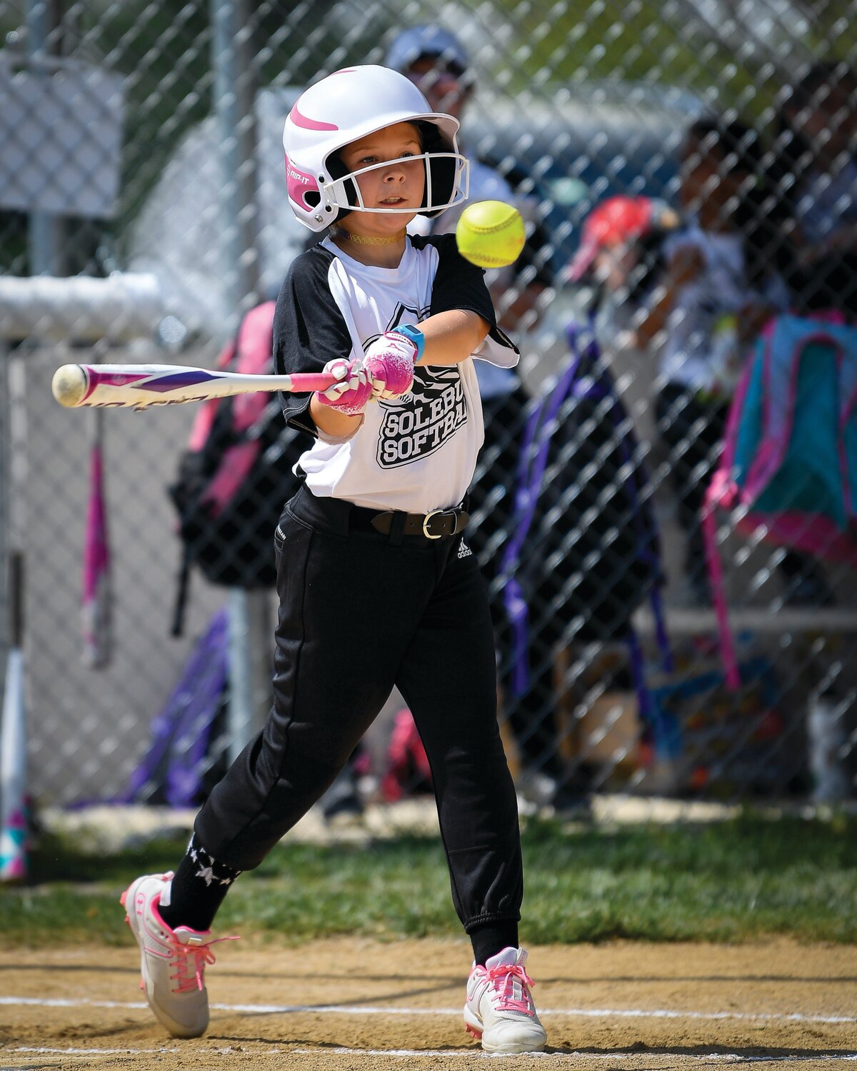 Keira Osmain leads off the first softball game of the season with a base hit.