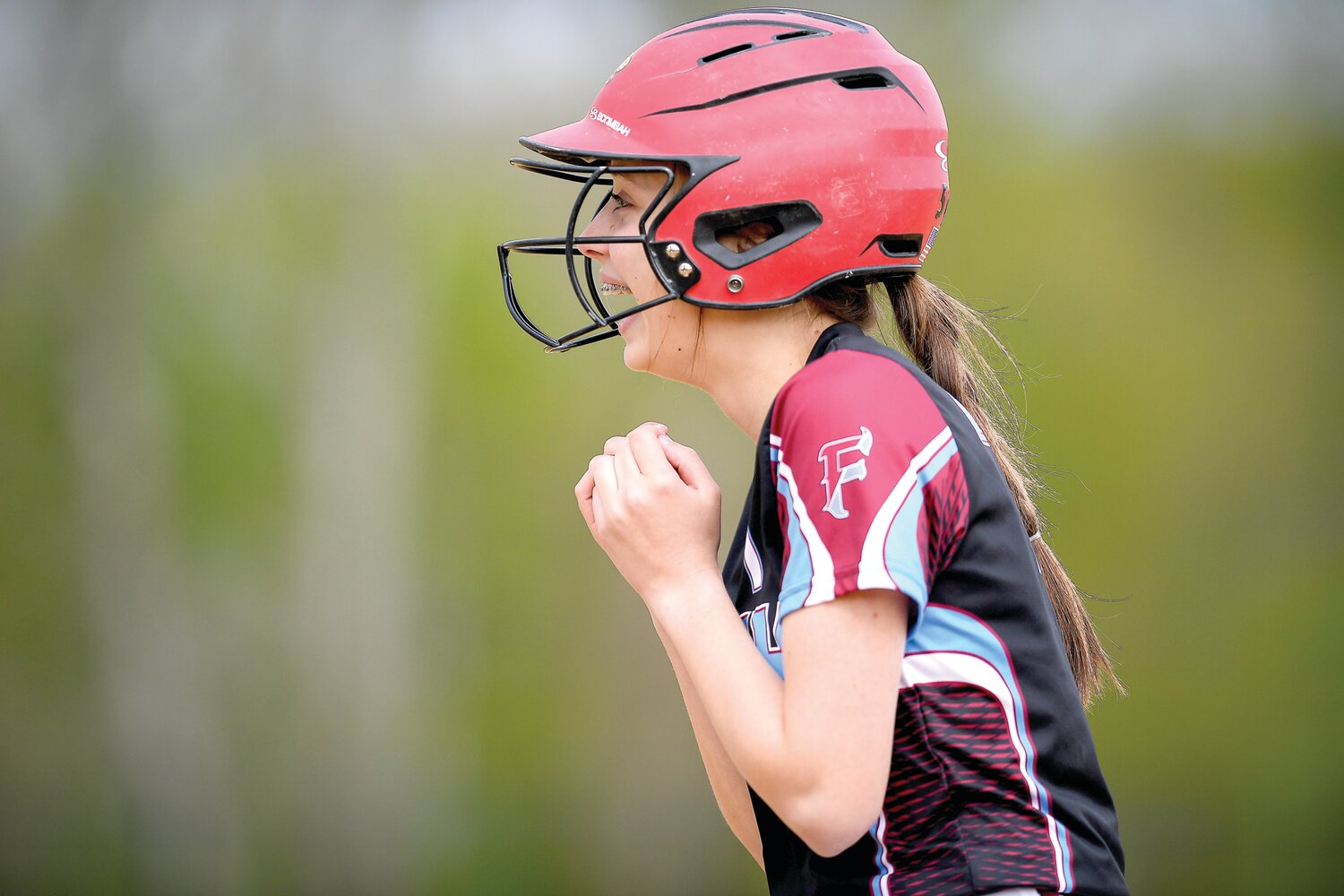 Faith Christian’s Mya Warshel is all smiles after a single during the 16-0 victory.