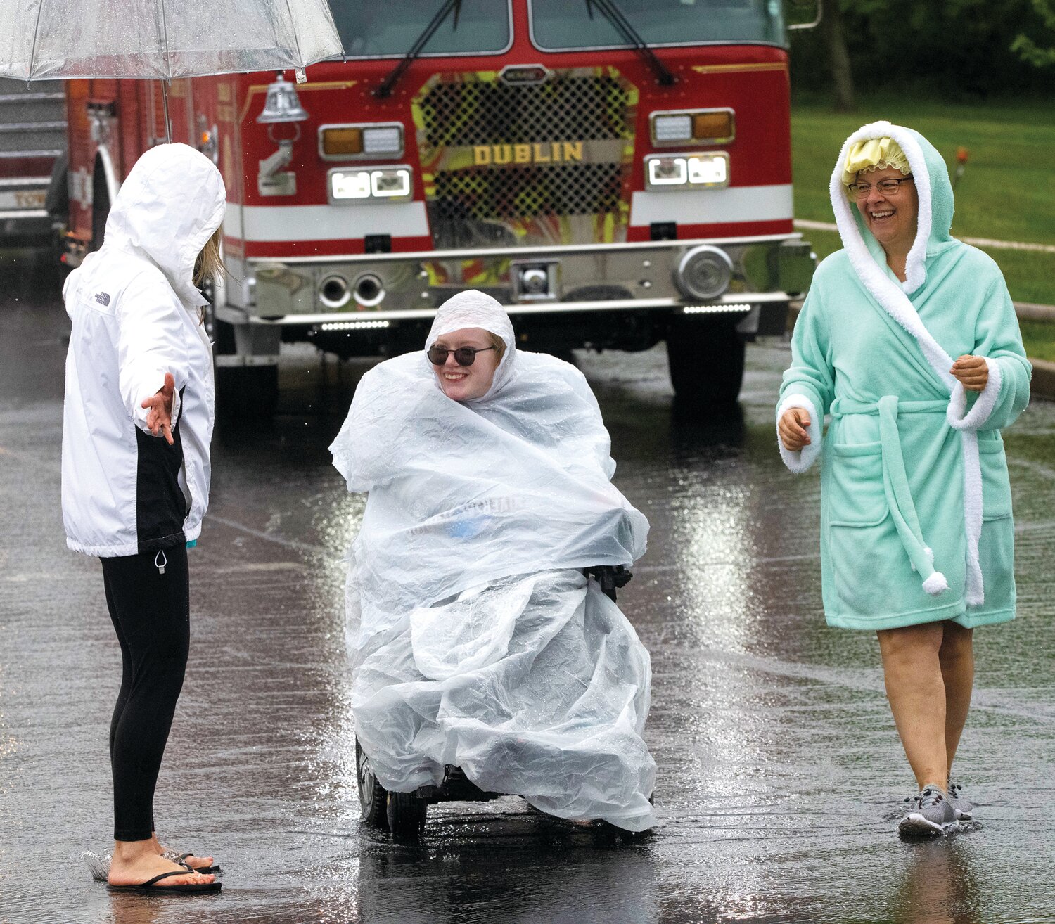 Liz Ratcliffe, center, goes through the showers with Michelle Boyer, caregiver, and Nicole Kreider, teaching assistant and Unified assistant coach.