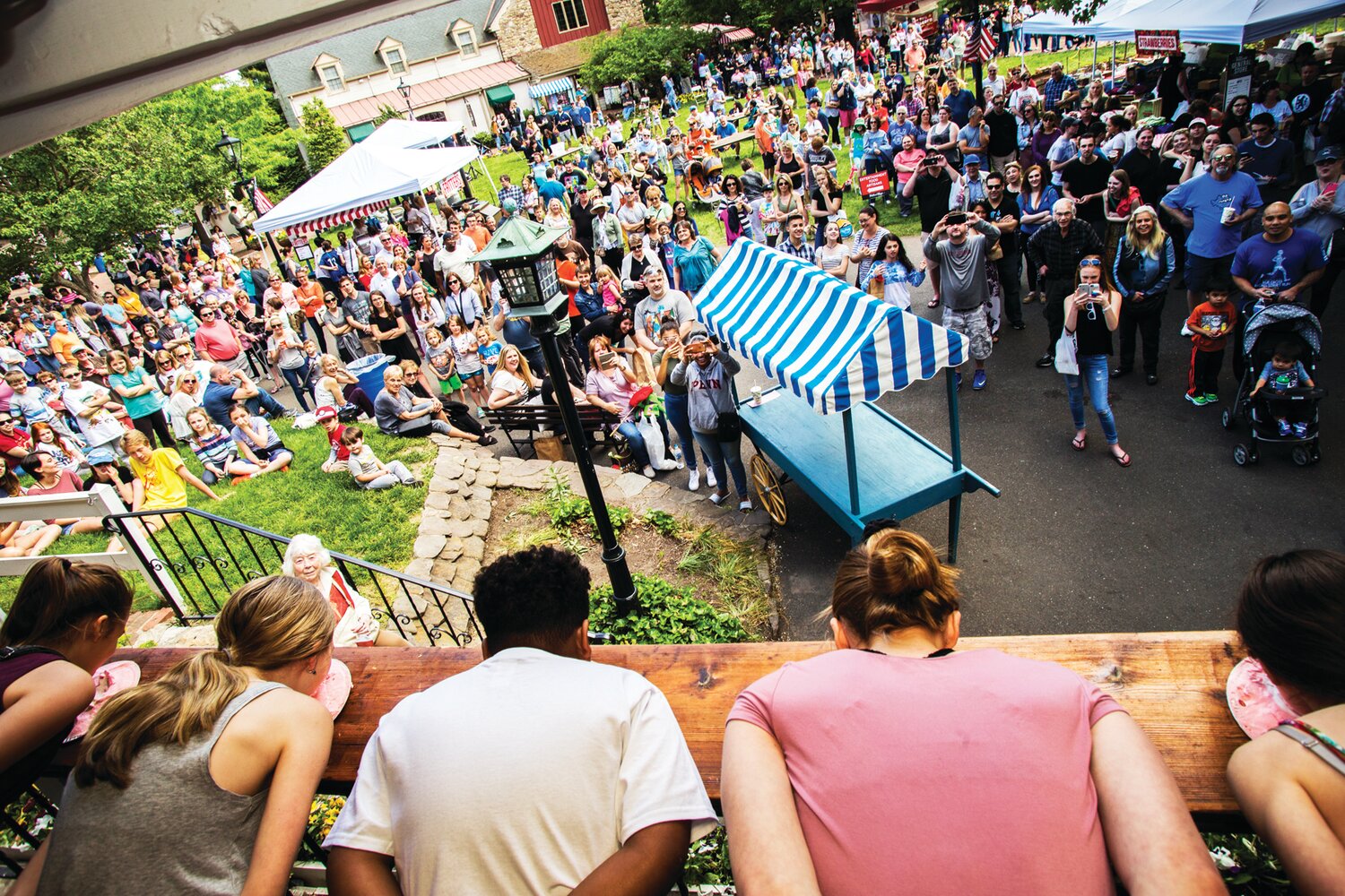 Festival-goers watch the strawberry pie-eating contest.