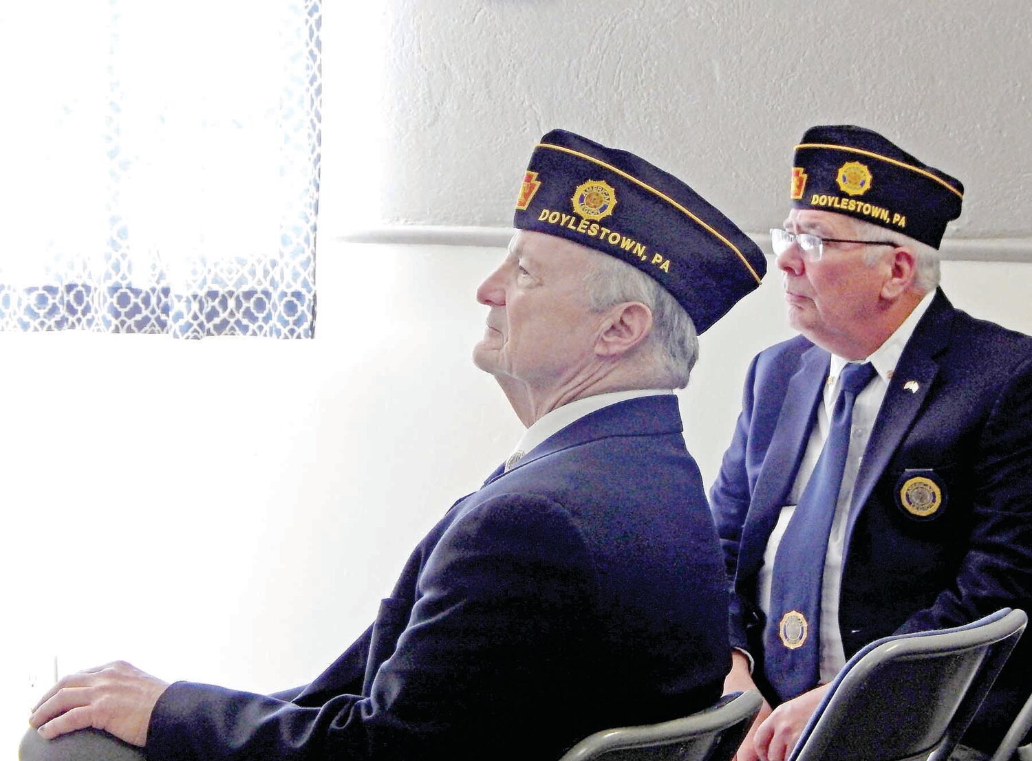 American Legion Post 210 Commander Pete Scott, left, and Vice Commander John Murphy listen to Green Beret and Post 210 Service Officer Bill Malone speak.