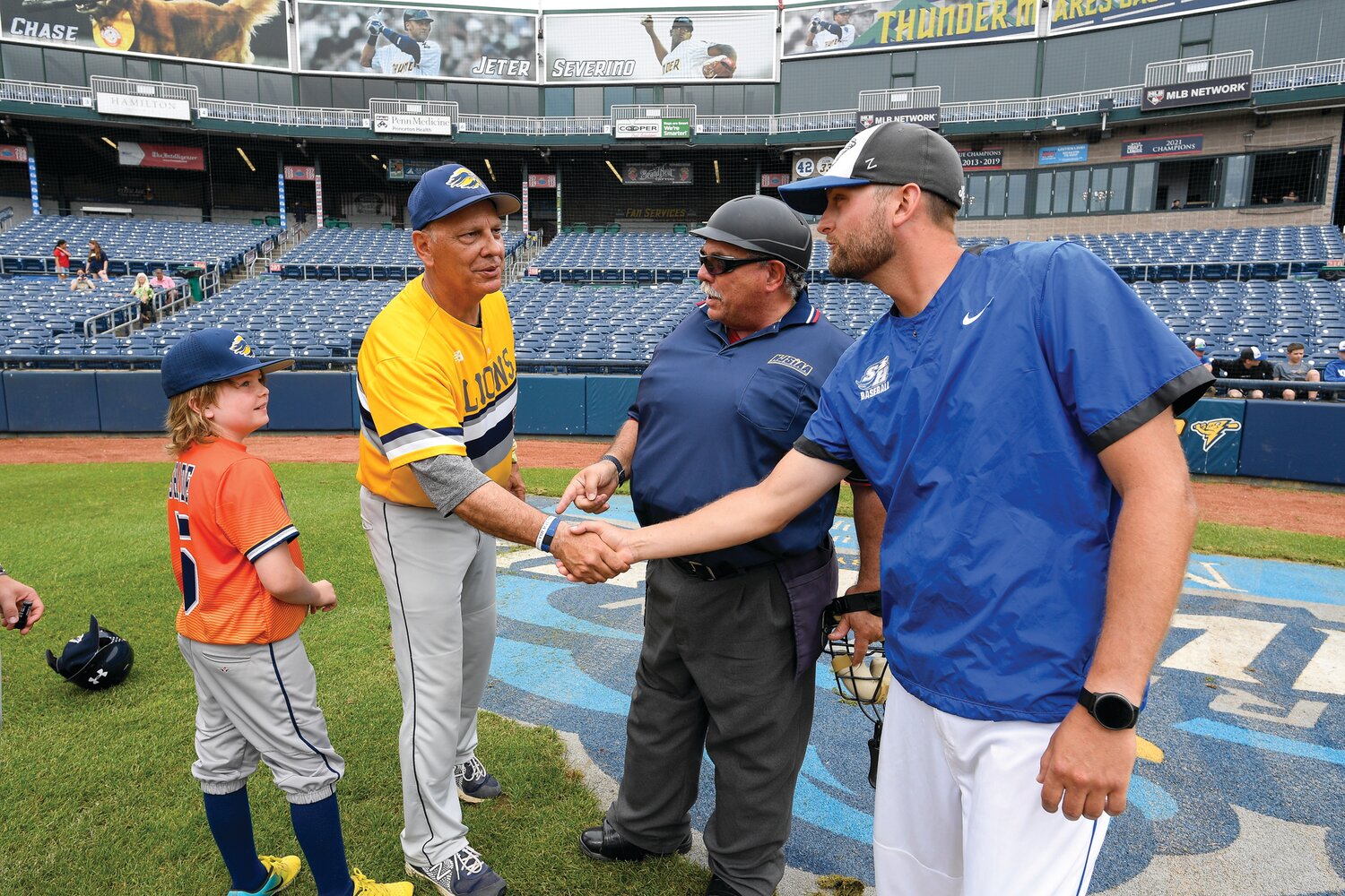 Managers Tony Vlahovic, New Hope-Solebury, left, and Chris Skolka meet at home plate.