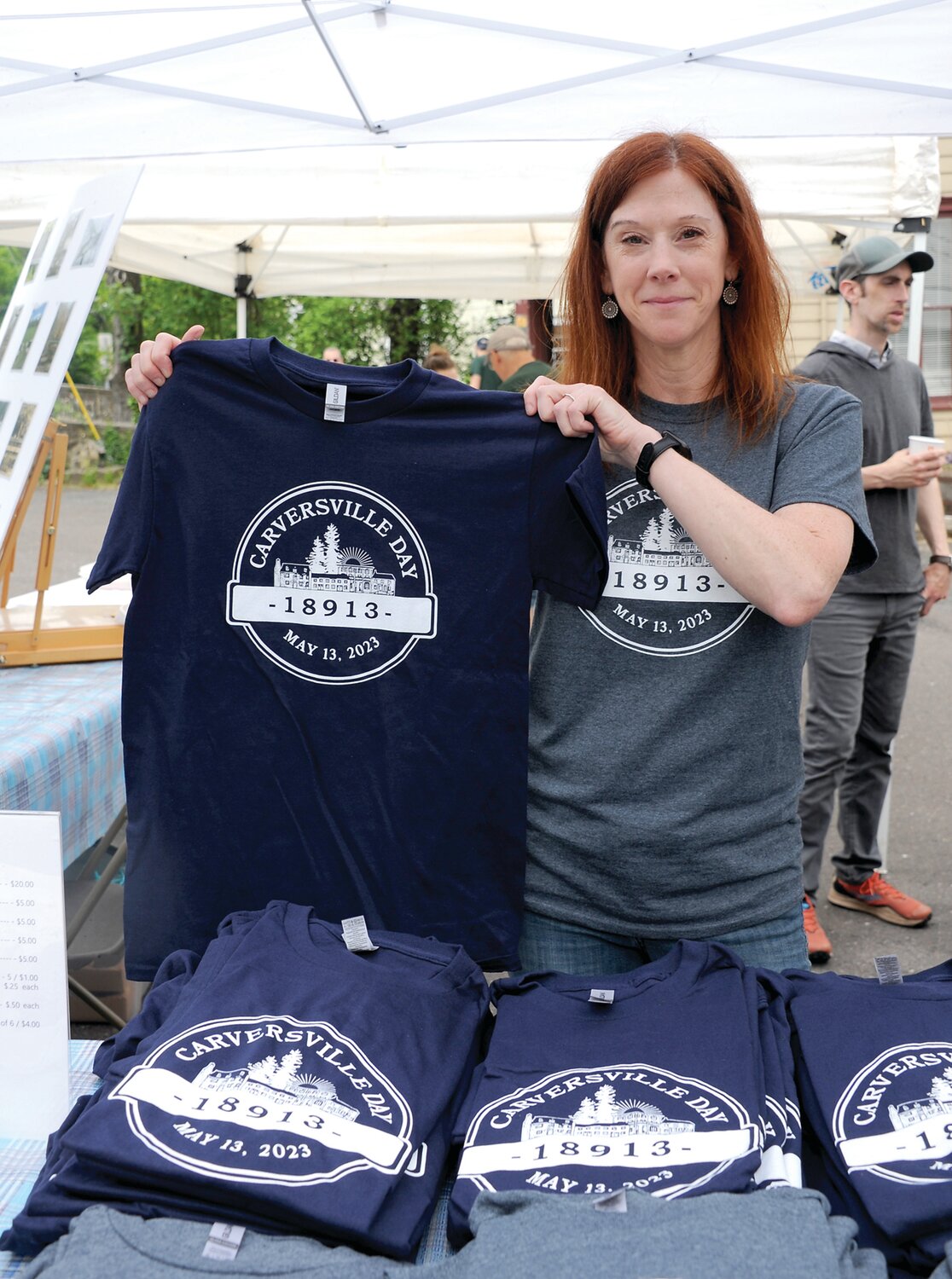 Sarah Weikerd mans the T-shirt booth.