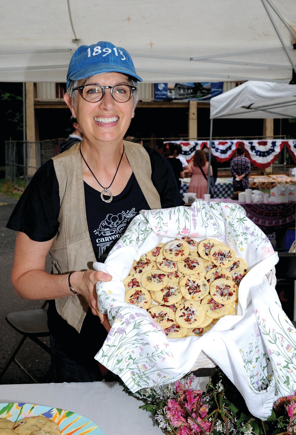 Kathy Stein with a basket of floral cookies.