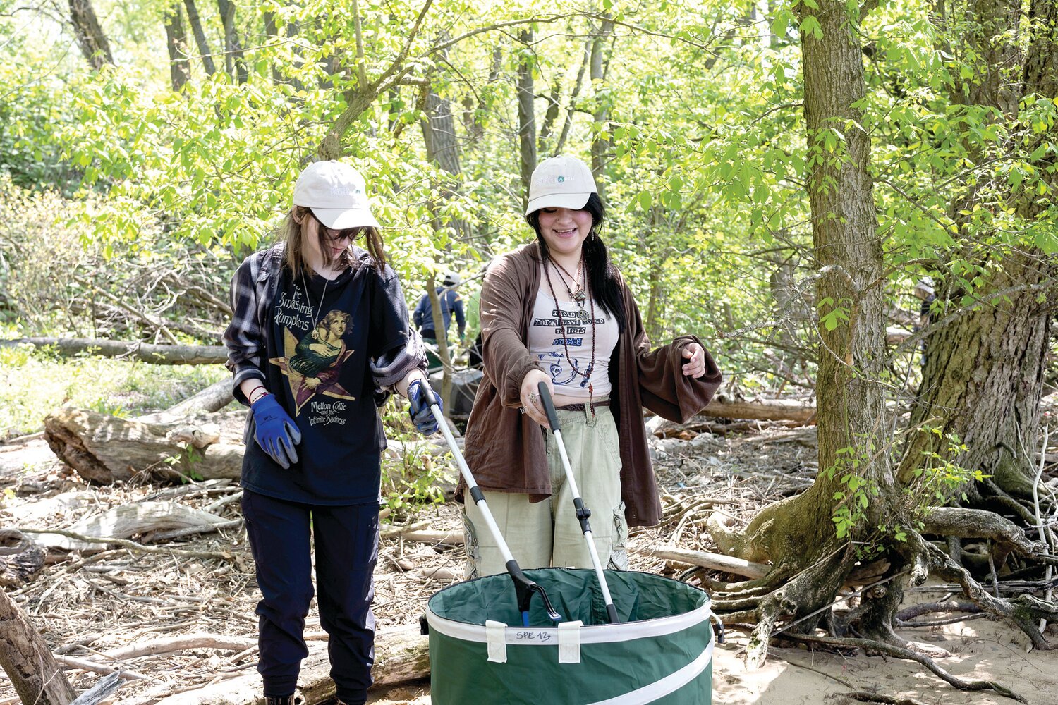 Student volunteers from Bucks Learning Cooperative laugh and chat as they contribute to cleanup efforts on Burlington Island. Spearhead Project Earth plans to clean 10,000 pounds of trash from Burlington Island by the end of 2023.