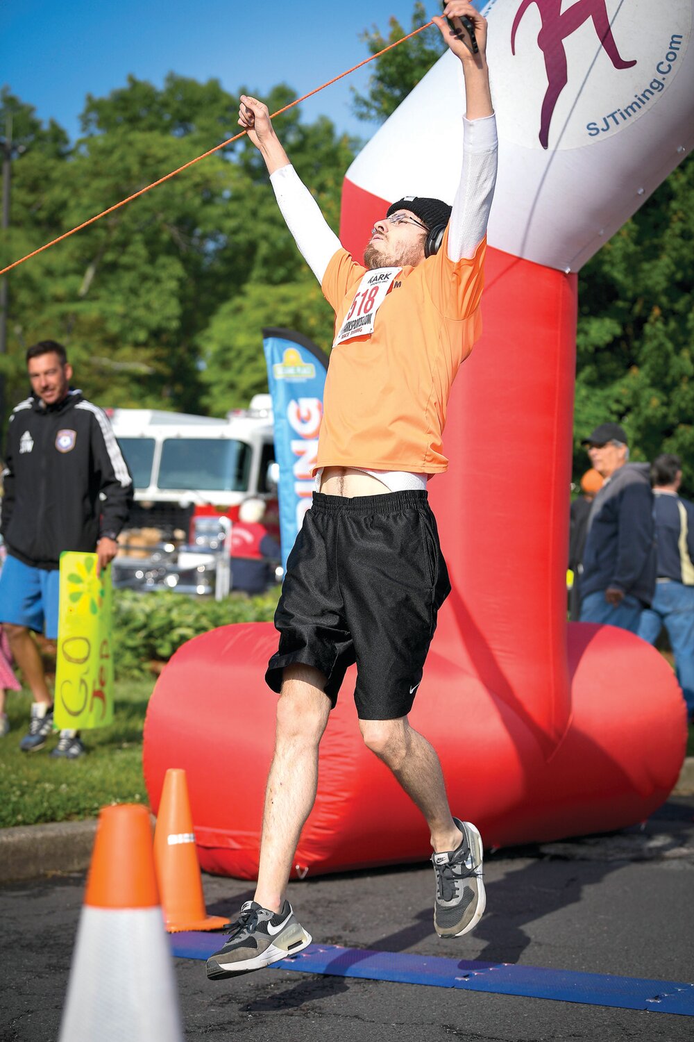 Wallace Nowacki of Fairless Hills crosses the finish line triumphantly in a time of 20:24.