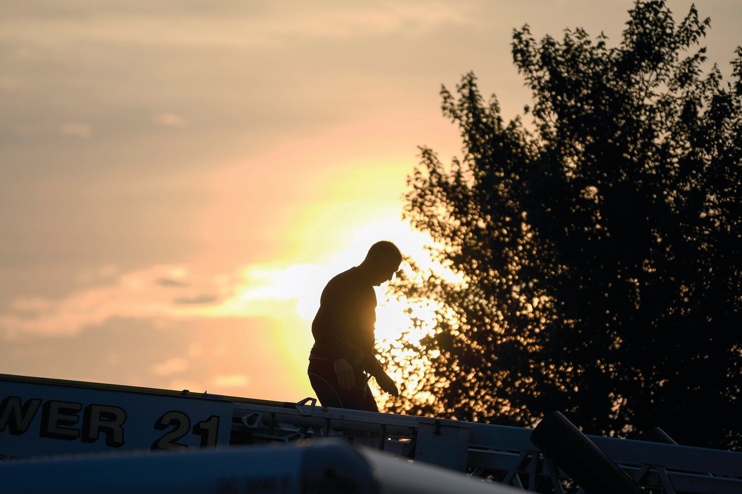 Steve Link of the Middletown Fire Department walks across the ladder after setting up the 5K banner.