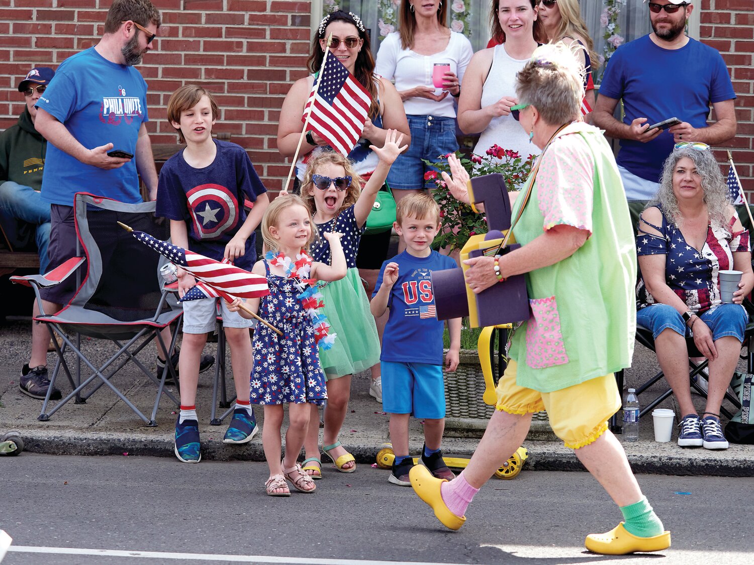 Liam DeGrasse, 9, Sophia Wisniewski, 4, Tessa Fleming, 6, and Finn DeGrasse, 4, have a good time at the parade.