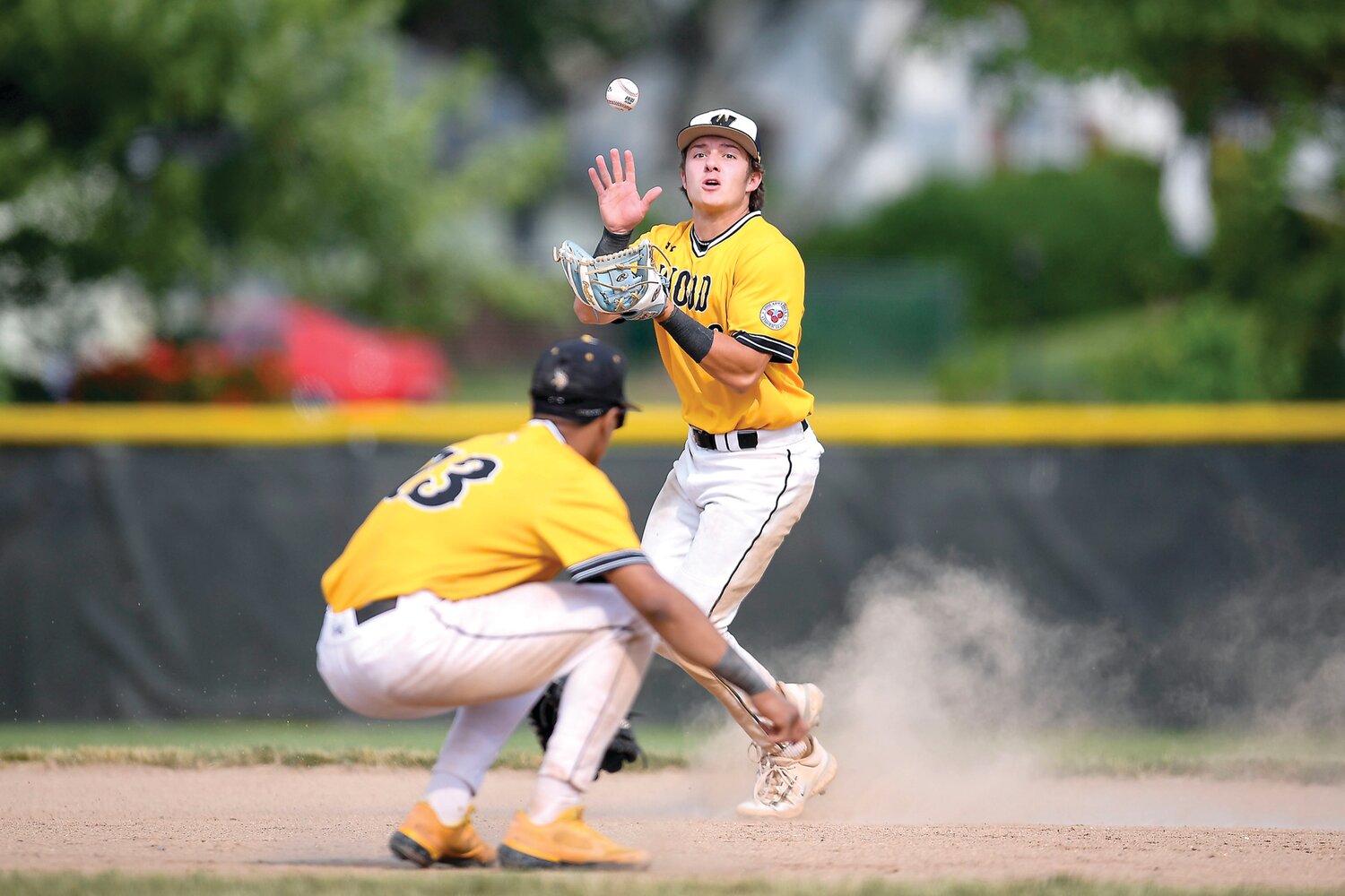 Vikings’ shortstop Patrick Gozdan tries to field a play in the hole with third baseman Dariel Tiburcio clearing the way.