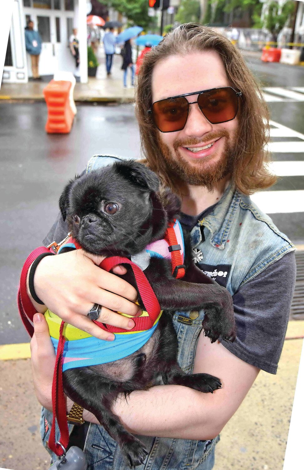 A pooch and a parade goer attend the PrideFest Parade.