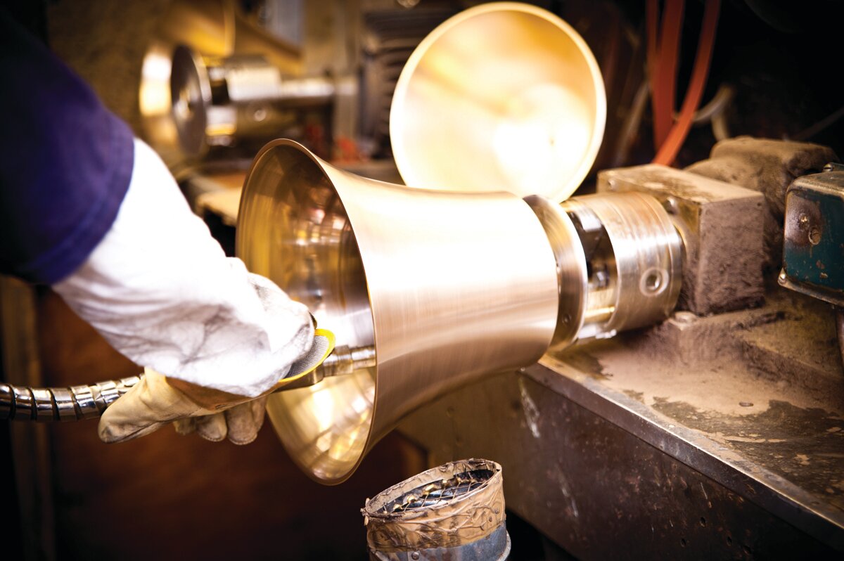 A handbell is being polished.