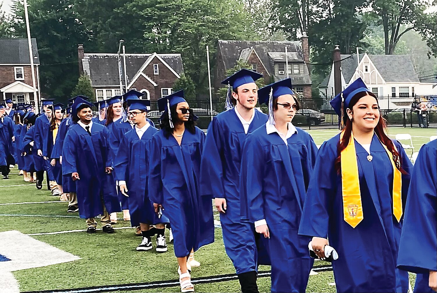 The Class of 2023 processes across Alumni Field to take part in Tuesday’s graduation ceremony.