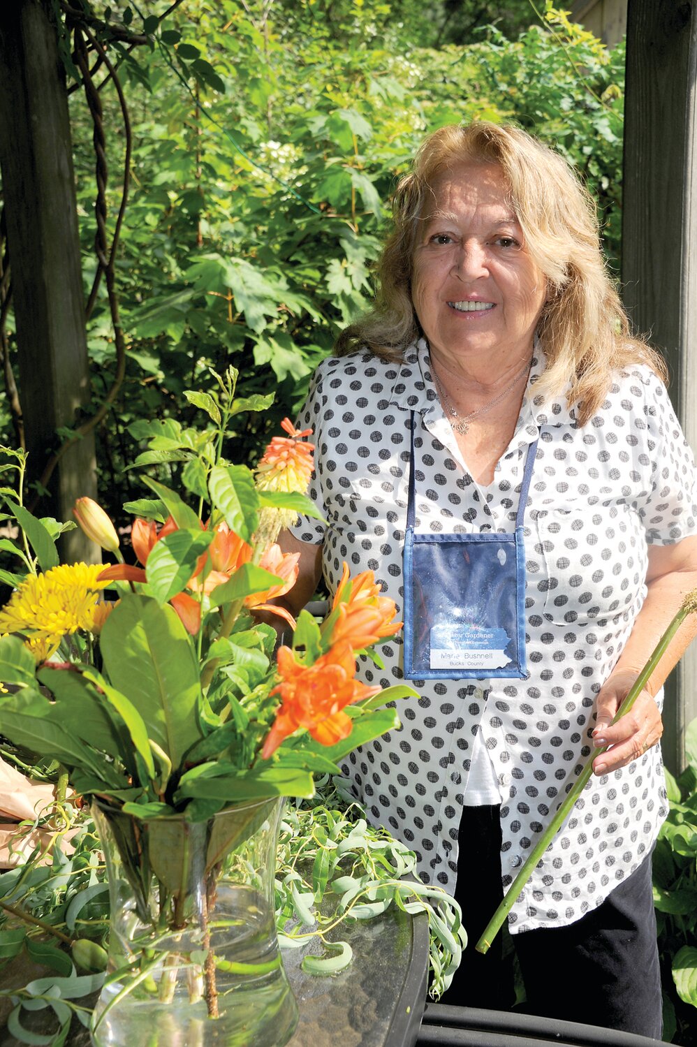 Marie Bushnell arranges flowers at the Borden residence.