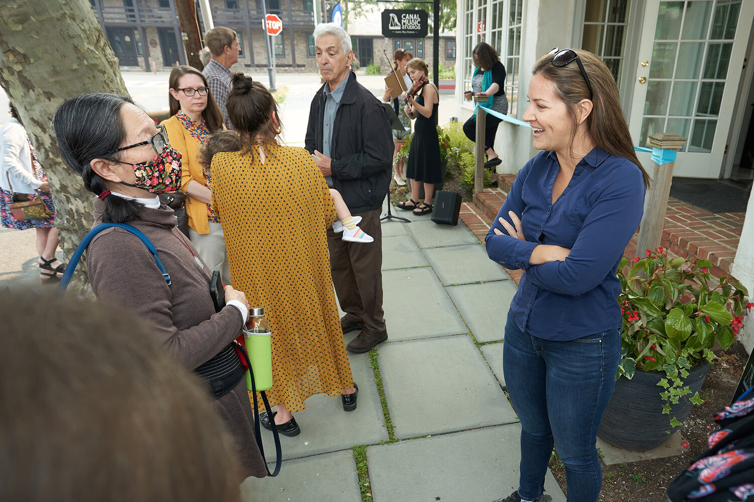 Attendees of Canal Music Studios’ recent grant reopening ceremony socialize in front of the business on Bridge Street in Stockton. The studios were destroyed by flooding in the wake of 2021’s Hurricane Ida when they were located in Lambertville.