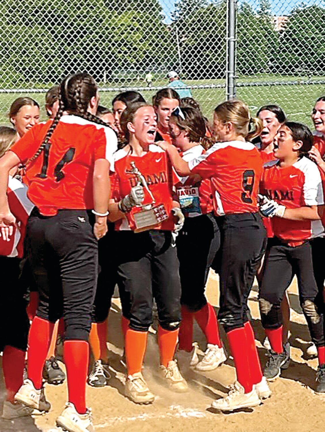 Paige Hartz, holding the trophy, was selected as the player of the game.