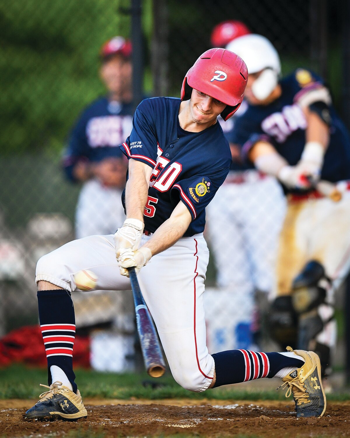 Plumstead’s Nate Wiseman drops down to get a base hit in the fifth inning.