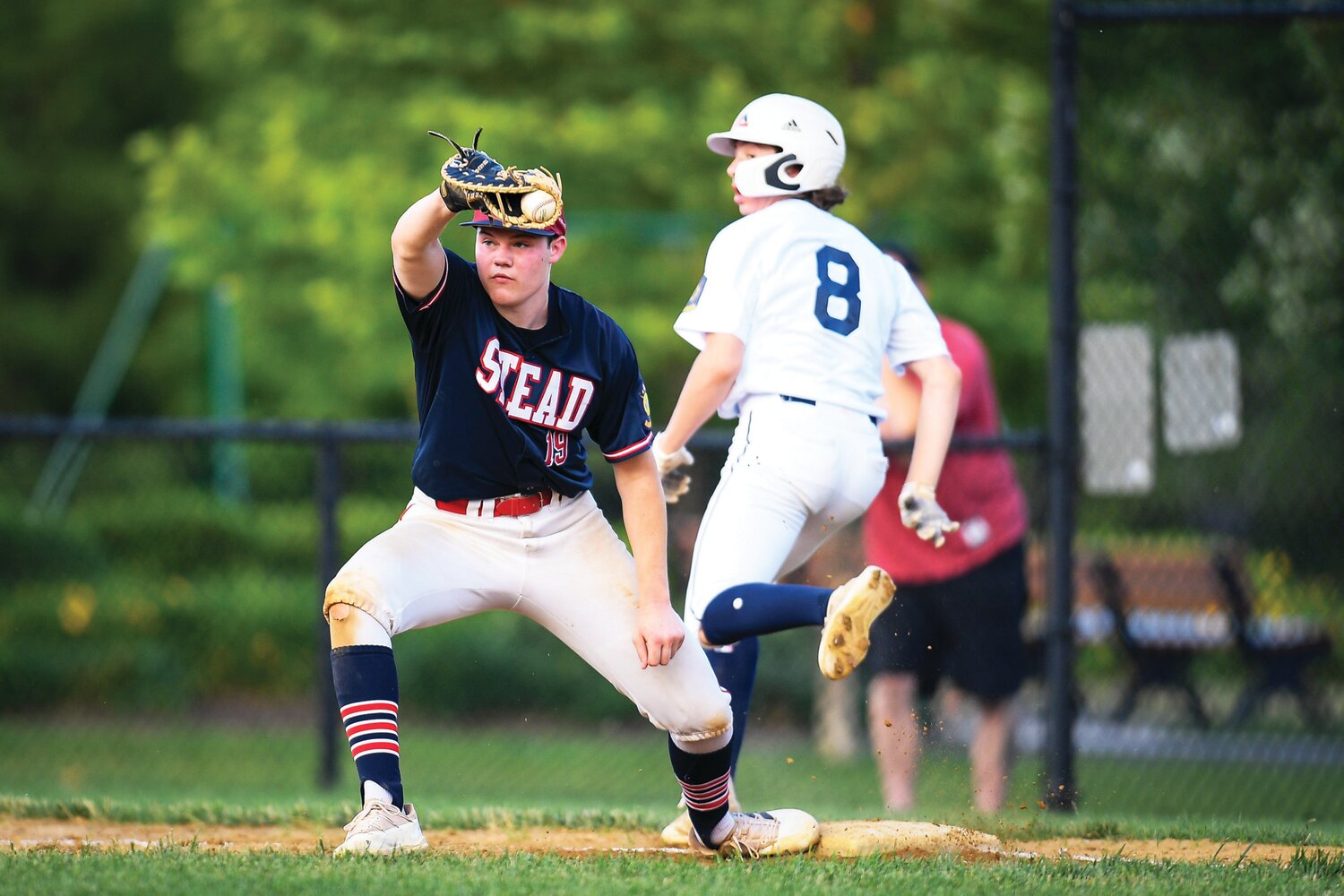 Plumstead’s Mike Wallbillich scoops a low throw to get Doyleotown runner Michael Graban in the fifth inning.