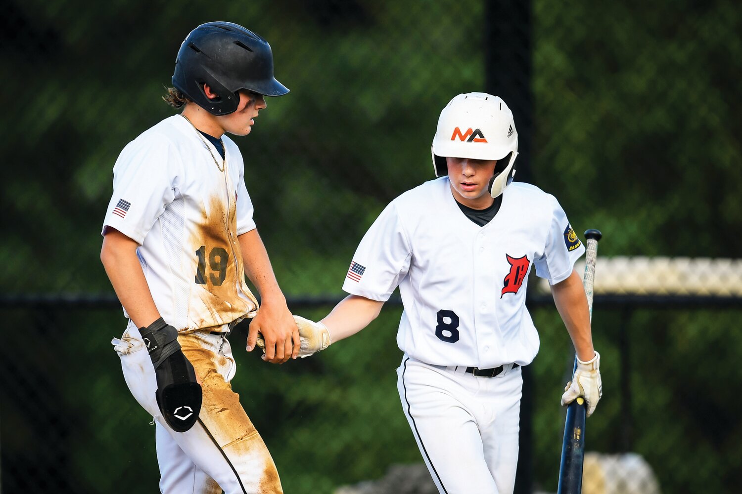 Doylestown’s Michael Graban congratulates teammate Ernie Sanchez after Doylestown took the lead in the top of the fifth inning.