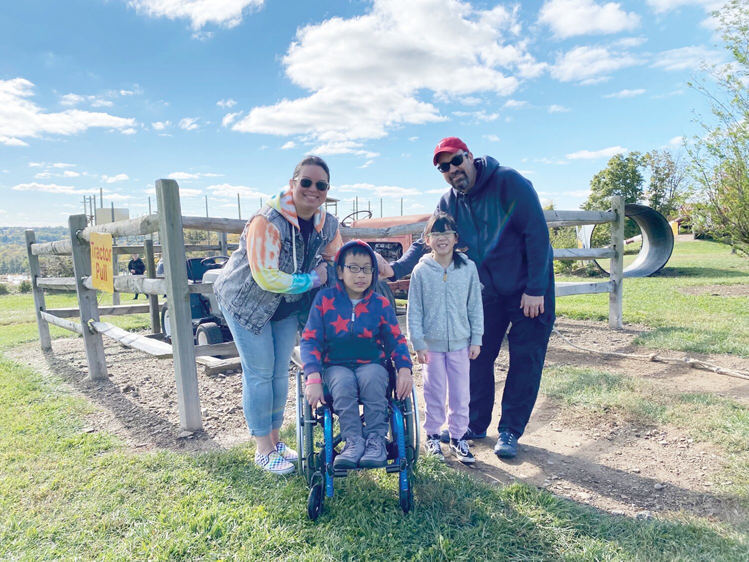 A family enjoys a day on the farm at an Autism Cares Foundation sponsored event.