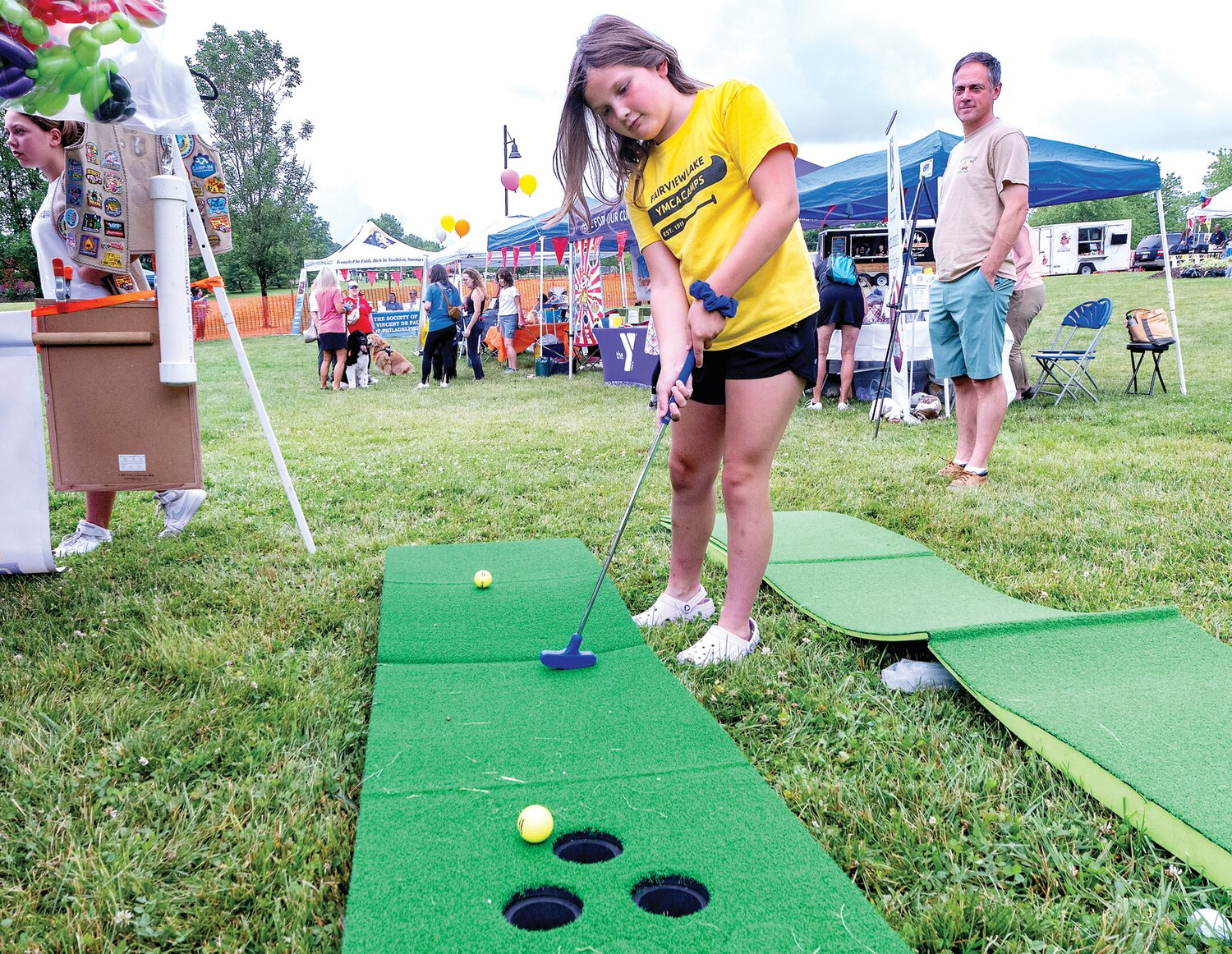 Eva Cambura enjoys a game of miniature golf during the Village Fair.