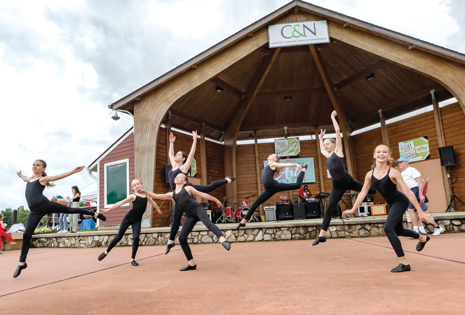 Dancers with the Bucks County School of the Performing Arts leap into the air during a performance Saturday afternoon for the Village Fair celebration at Central Park.