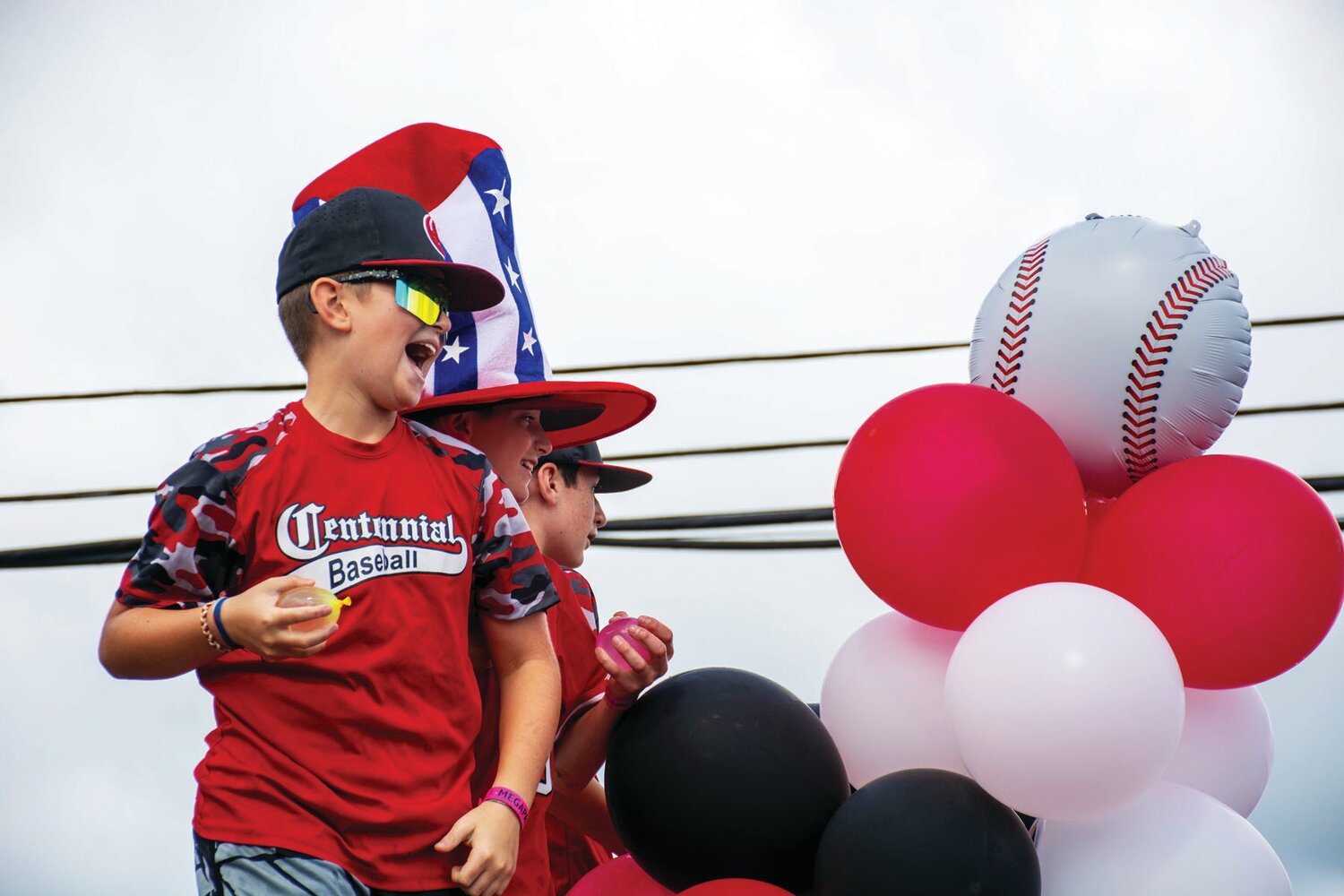 Members of Centennial Baseball participate in the parade.