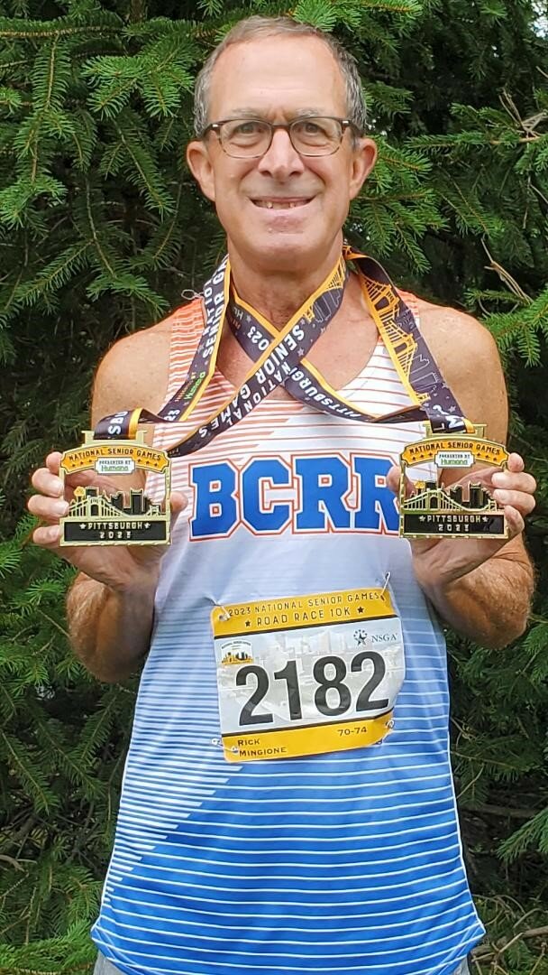 Rick Mingione displays the gold medals he received at the National Senior Games in Pittsburgh.