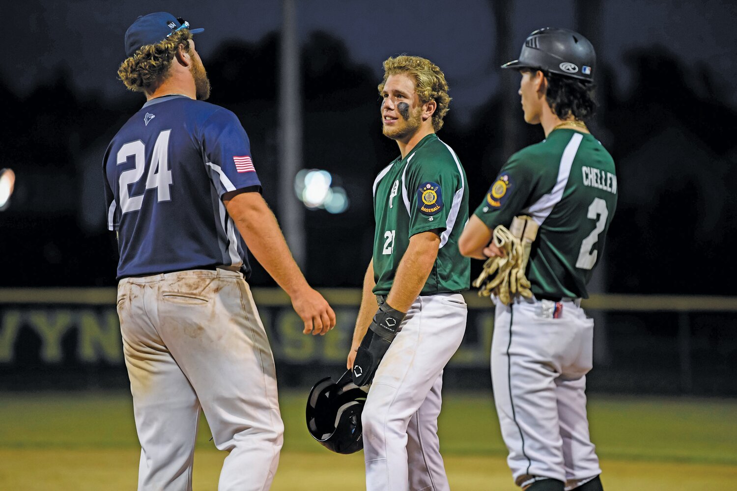 Pennridge’s Nate Lapp and Quakertown’s Vinny Pellegrini catch up during a fourth inning pitching change.