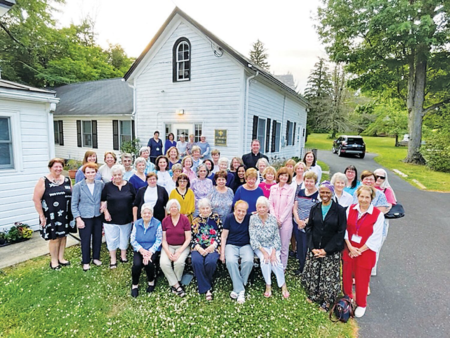 The 2023 class picture of the Ladies of Mount Carmel, along with the Rev. Matthew Guckin, pastor of the church in Doylestown.