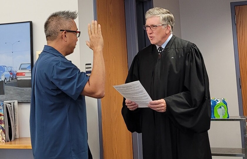 Michael Hsu takes the oath of office Thursday night upon being selected to fill a vacancy on the Palisades School Board.