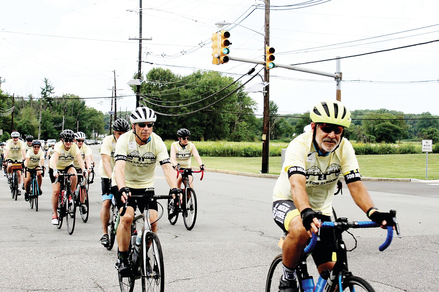 Joe  Boyce, behind Griff Humphries, rides from Pennington, N.J., to the Quaker Bridge Mall with the entire Anchor House team on Saturday.