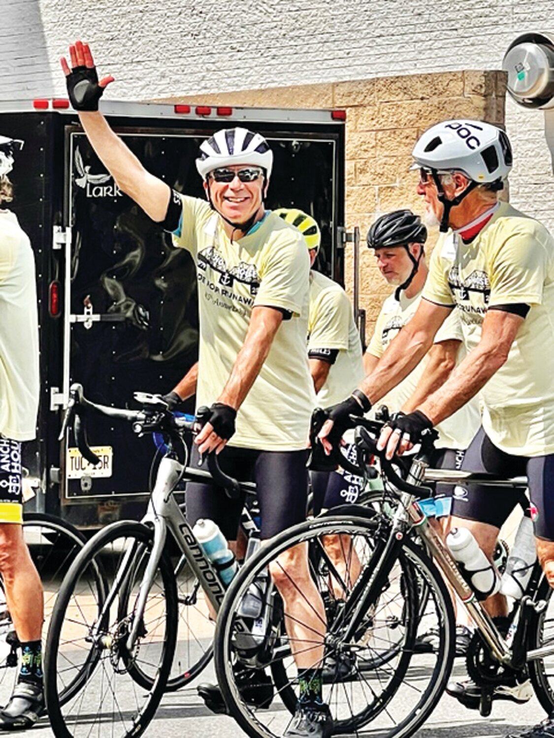 Joe Boyce at the Quaker Bridge Mall waves to the Bucks County Roadrunners who came to cheer the finish.