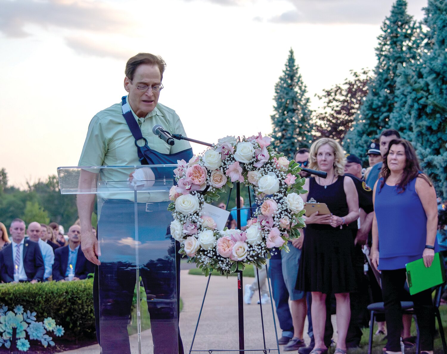 Flash flood survivor Dave Love, husband of victim Yuko Love, speaks at the vigil.