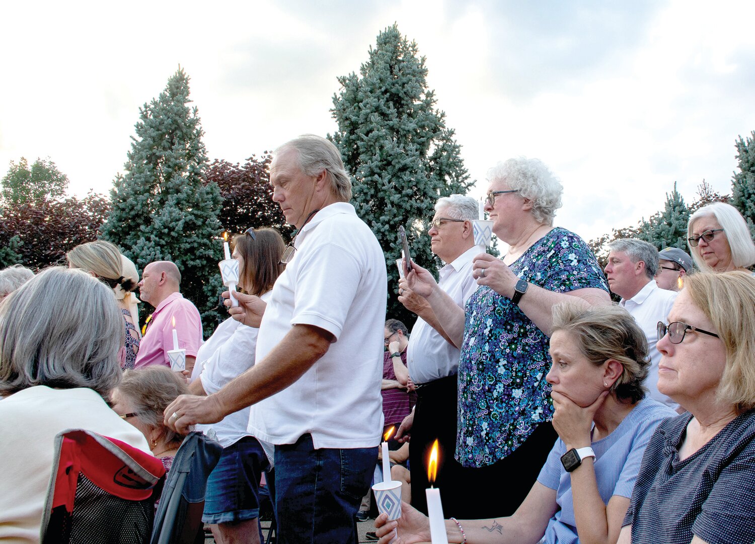 Attendees hold candles at the vigil.