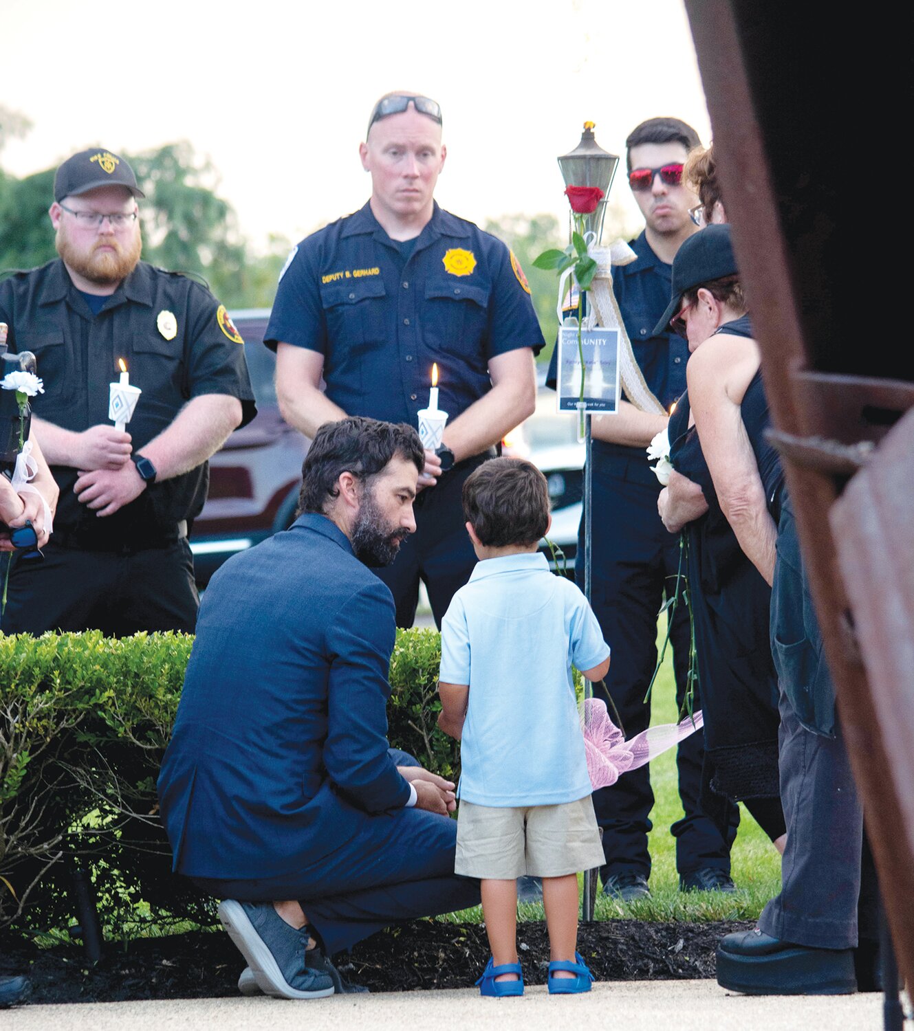 Jim Sheils and his son place flowers for Katie Seley.